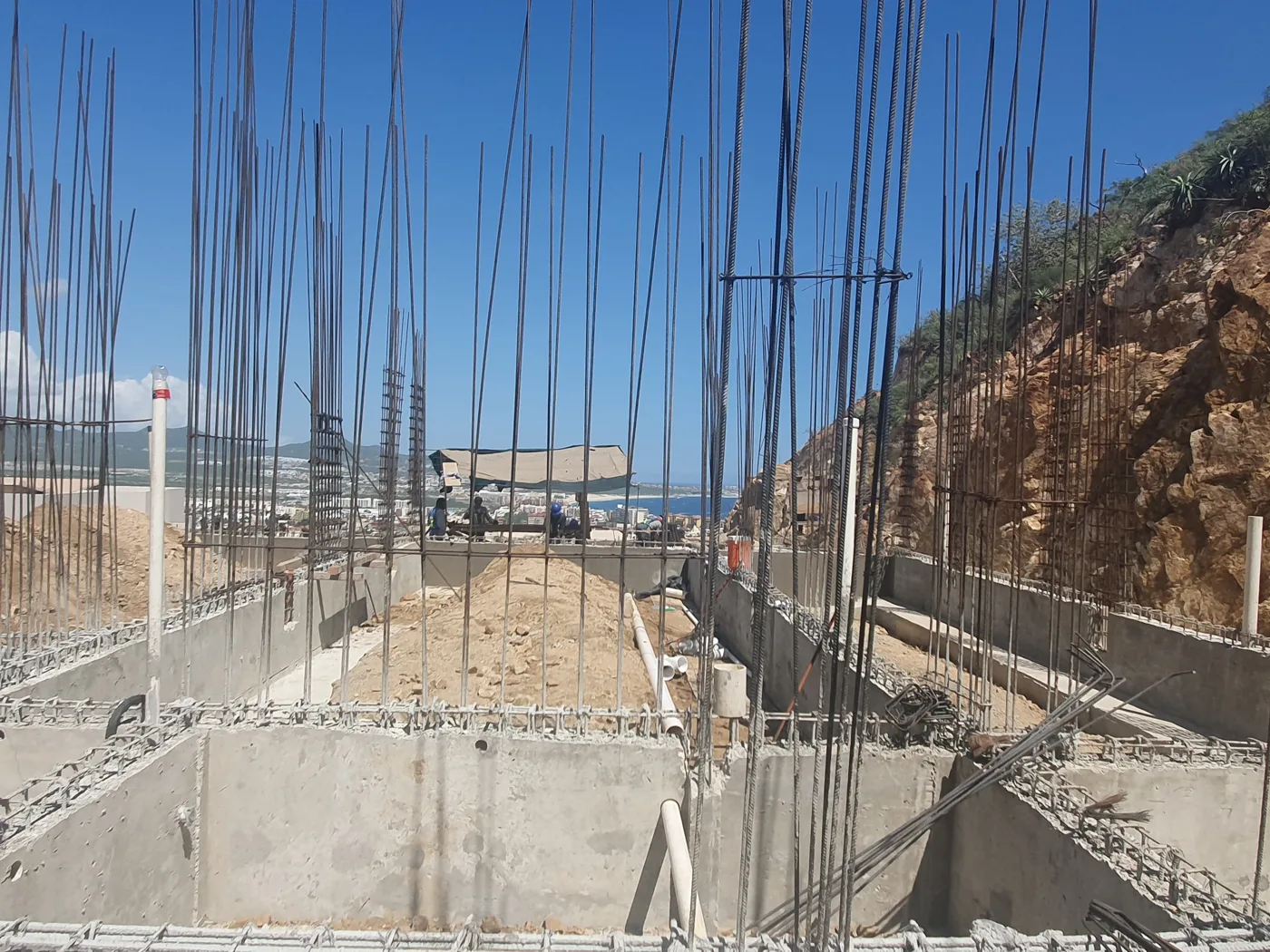 Concrete foundations and vertical reinforcing steel during later construction