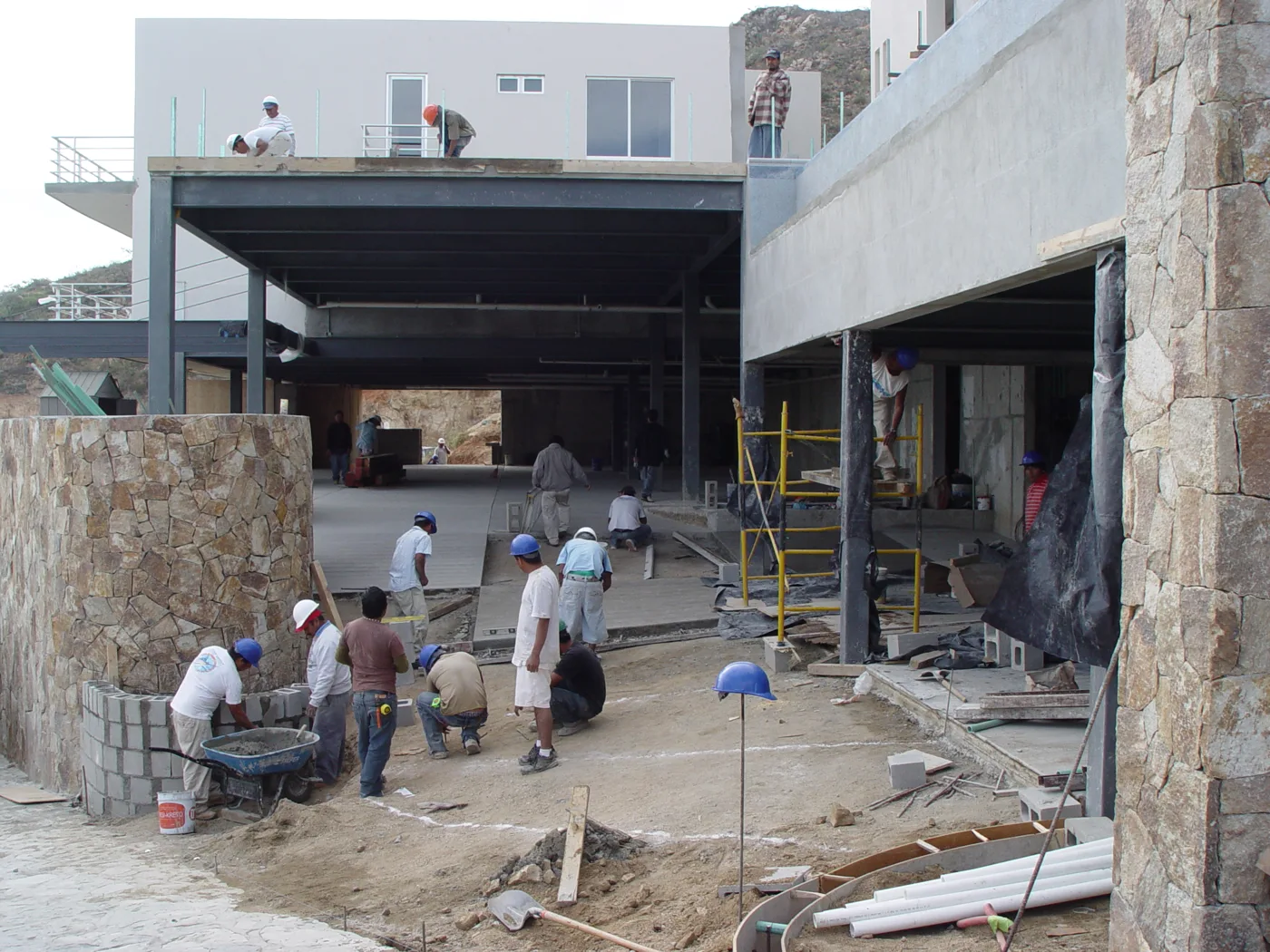 Workers completing outdoor areas between Las Cascadas buildings